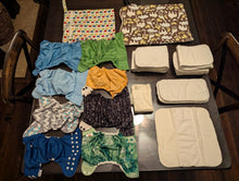 Load image into Gallery viewer, Cloth diaper covers, inserts and 2 wet bags 8 covers, 13 inserts, 6 nwbn inserts, 1 trifold, 2 wet bags Potty and Diapering
