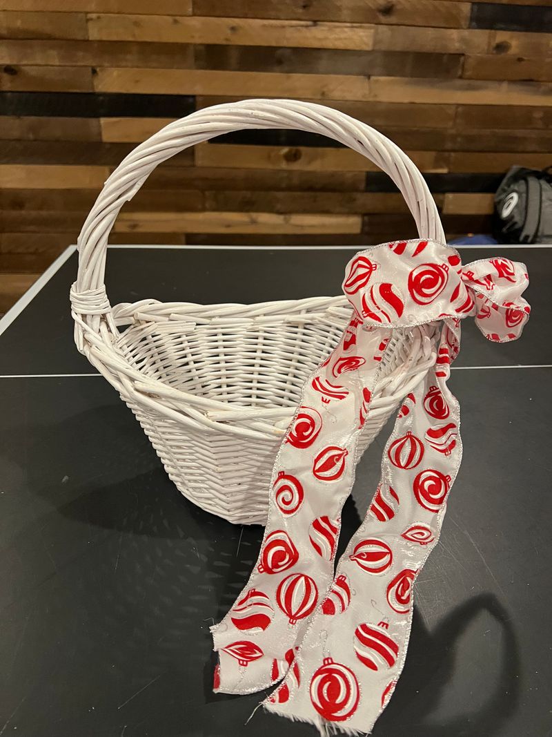 One large white wicker basket with Christmas ribbo Round white basket about 12 inches tall