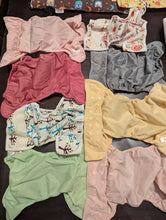 Load image into Gallery viewer, Cloth diaper covers, inserts and 2 wet bags 8 covers. 18 inserts, 1 trifold, 2 wet bags, roll of dry wipes Potty and Diapering
