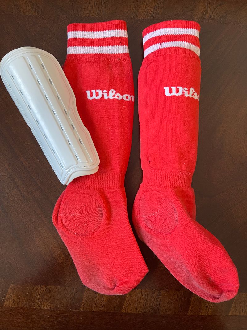 Wilson coral colored soccer socks with removable shin guards