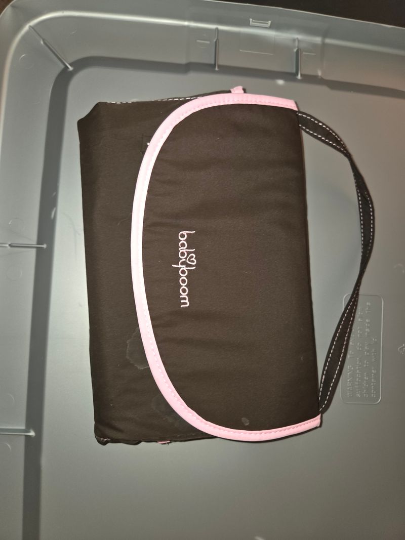 Folds out changing pad Pink pad on inside Potty and Diapering