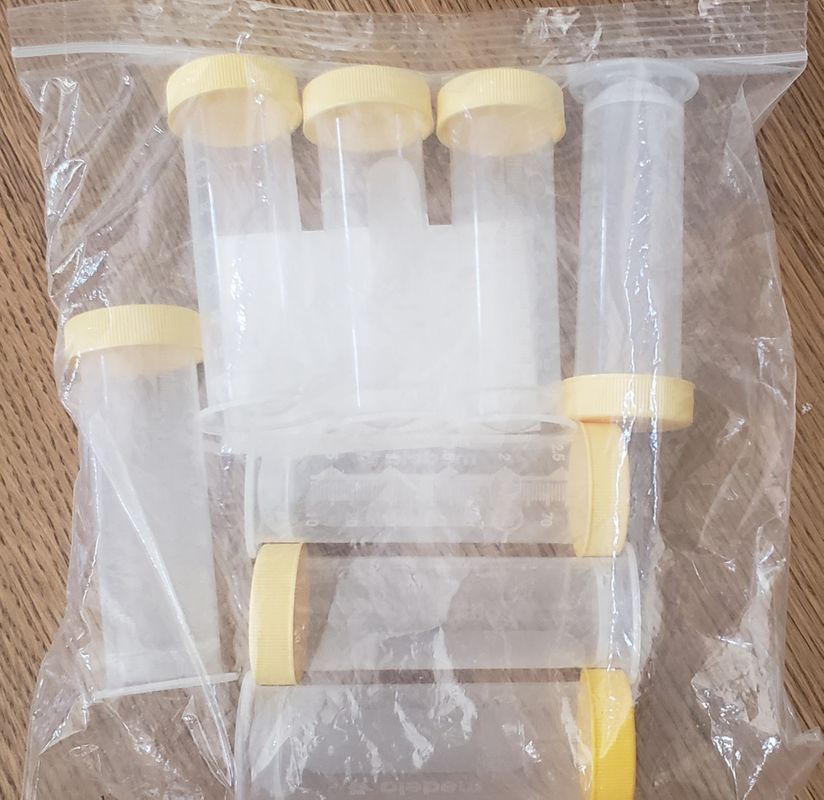 8 small Medela pump bottles with caps