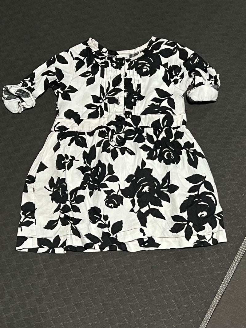 Carter’s white top with black flowers Top is longer, could be used as dress 12 Months