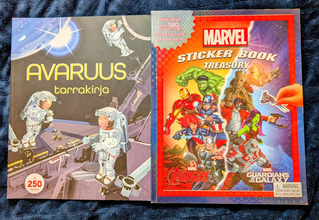 2 sticker books 1 space themed from Finland, 1 marvel theme, mostly unused Workbook