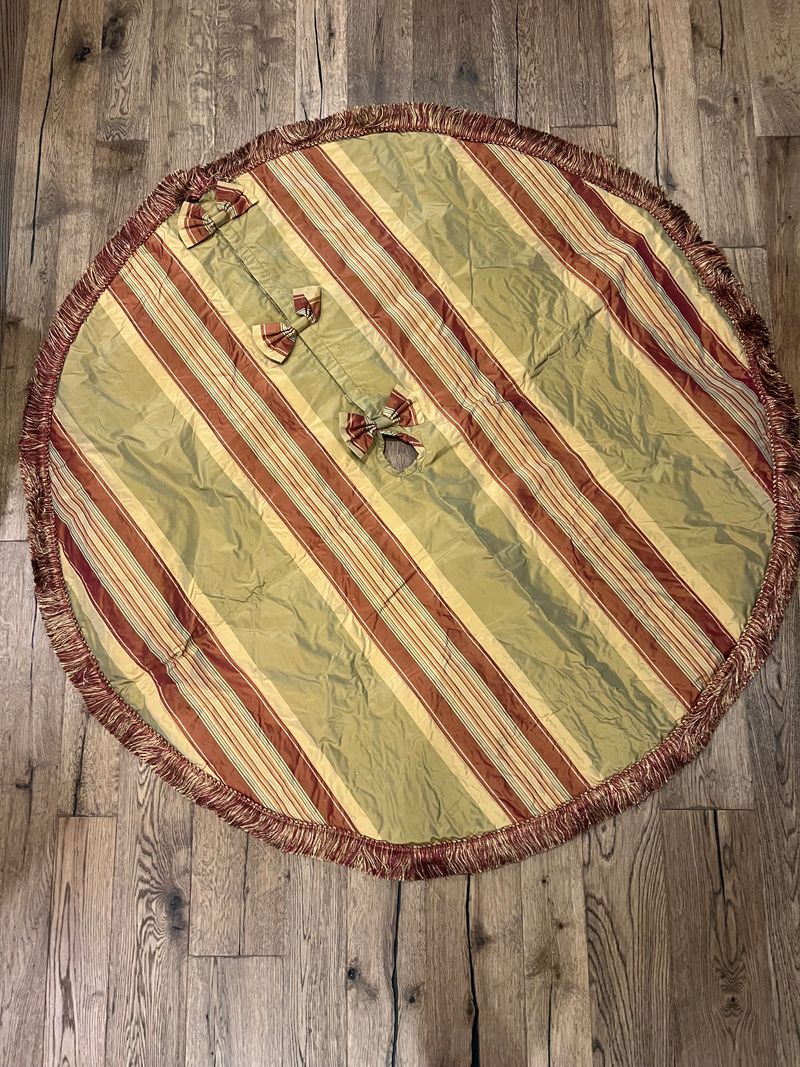 1 round large custom tree skirt with fringe & bows golds, red, greens with fringe and lined underneath