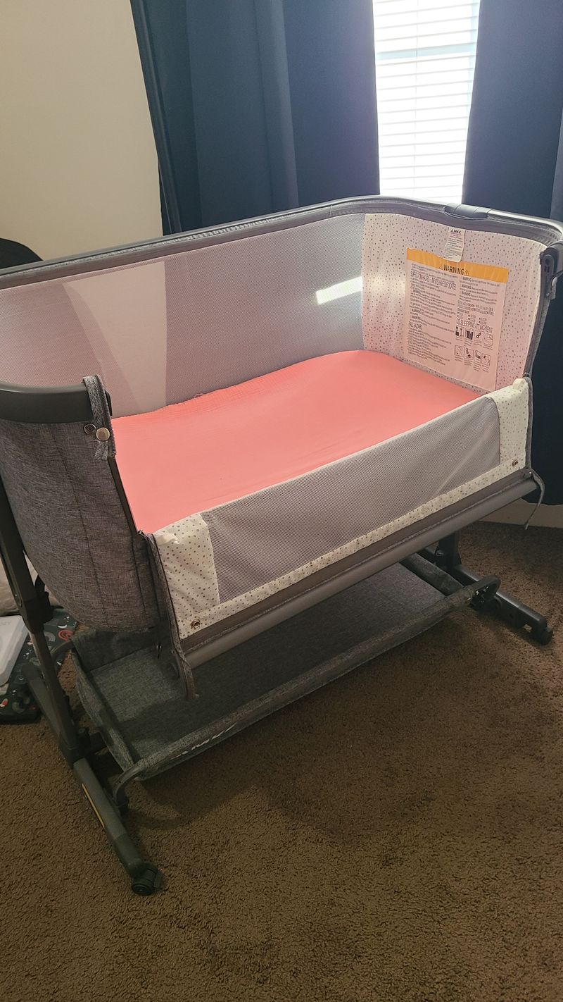 AMKE Unisex Bassinet. I have 2 girl fitted sheets if you want. Crib