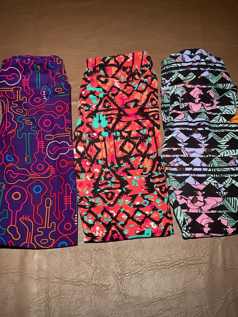 3 Lula Roe leggings actual size says One size purple w/guitars/coral/ blk/green and blk/pink/purple 10