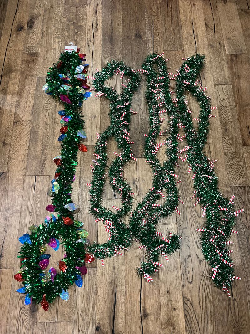 4 strands of various tinsel and garland 1 with lights and 3 with candy canes