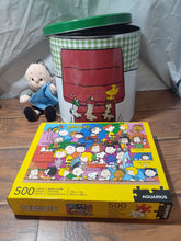 Load image into Gallery viewer, 3pc Peanuts lot metal can with lid, 500pc puzzle and Linus 8&quot; plush doll
