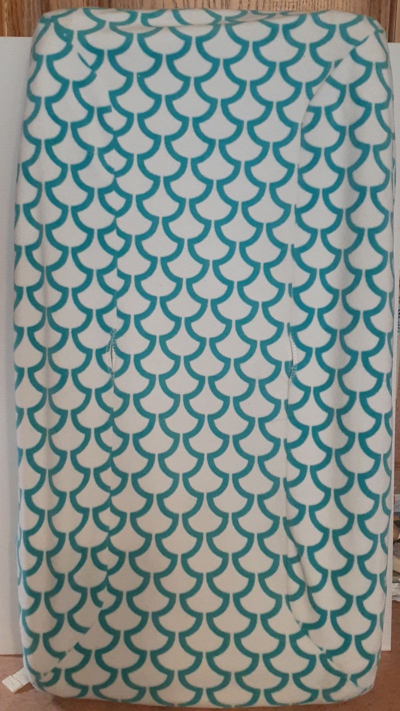baby changing contour pad with teal scale design cover
